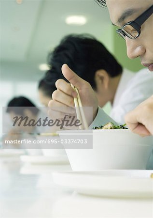Business executives eating in cafeteria