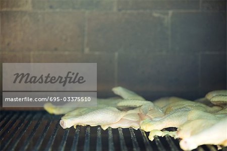Poultry grilling in wood oven