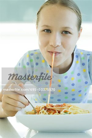 Girl slurping spaghetti noodles