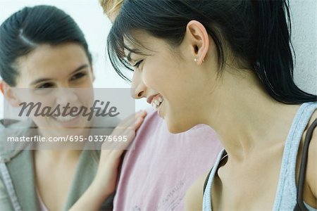 Young friends laughing, close-up