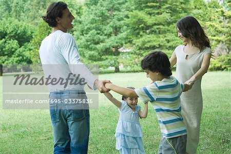 Family outdoors playing ring-around-the-rosy