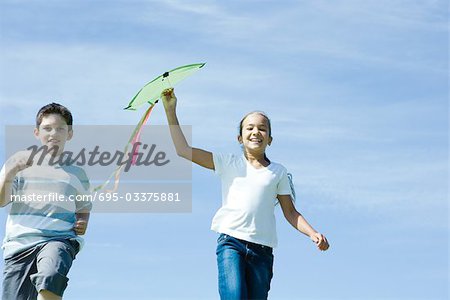 Girl holding up kite