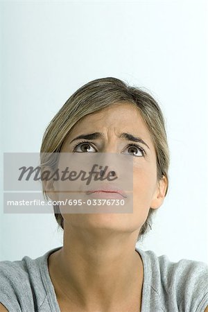 Woman furrowing brow, looking up, portrait