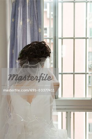 Bride facing window, rear view