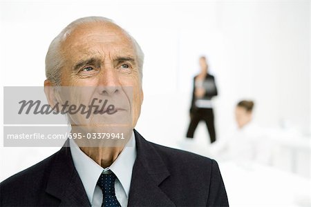 Senior businessman looking up, portrait