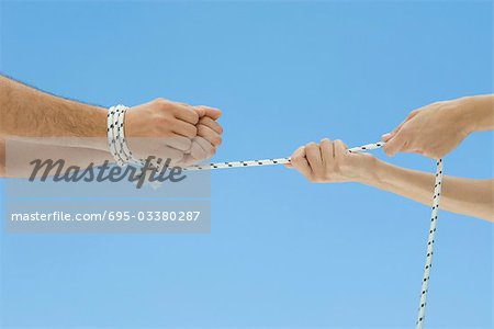 Male hands bound by rope, female hands pulling rope, cropped view - Stock  Photo - Masterfile - Premium Royalty-Free, Code: 695-03380287