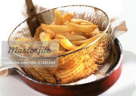 French fries in frying basket, close-up