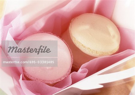Macaroons in box with pink tissue paper, close-up