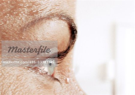 Woman S Eye And Wet Skin Close Up Side View Stock Photo