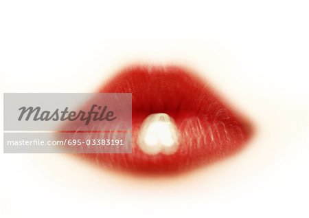 Woman wearing red lipstick, close up of mouth, blurred.