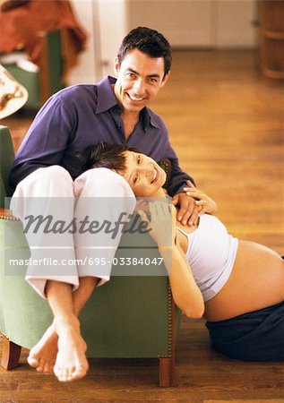 Pregnant woman sitting on a chair Stock Photo