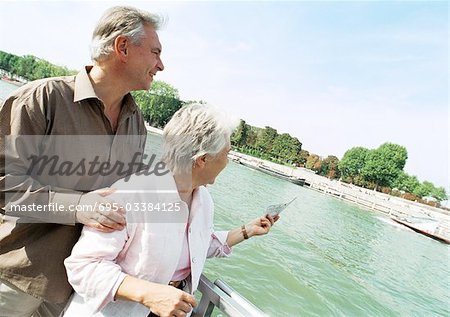 France, Paris, mature man and woman on a boat in the River Seine