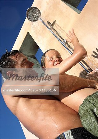 Man holding child in shower.