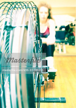 Woman using rowing machine in gym