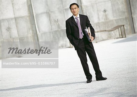 Businessman standing outdoors, portrait
