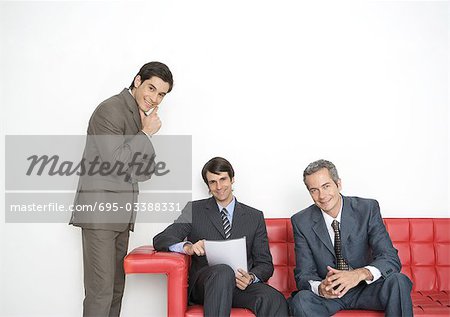 Three businessmen in office lobby