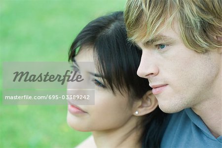 Young couple, looking away, close-up