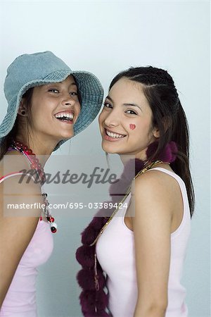 Two young female friends, smiling at camera, portrait