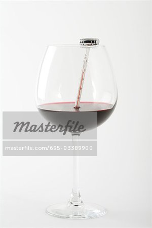 Thermometer in glass of red wine