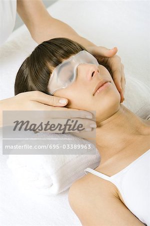 Woman wearing face mask and receiving facial