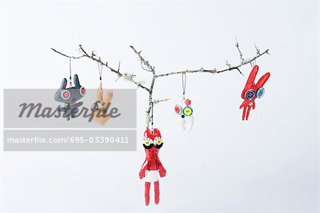 Cell phone charms hanging from branches