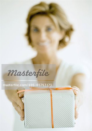 Woman holding out present