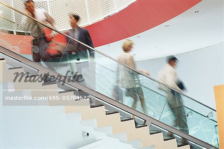 Business executives going up and down staircase