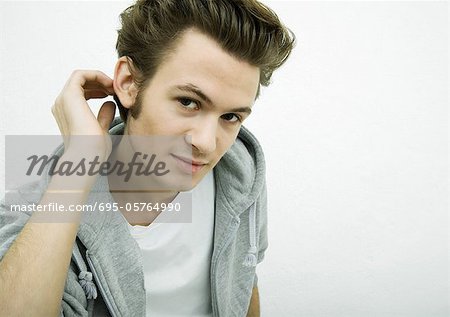 Young man leaning toward camera, portrait