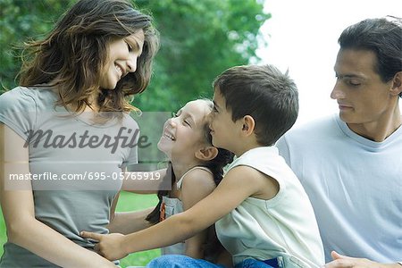 Family outdoors, smiling