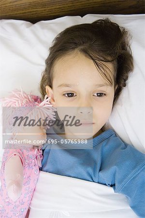 Girl lying in hospital bed