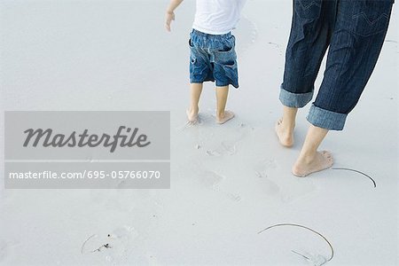 Father and child walking on beach