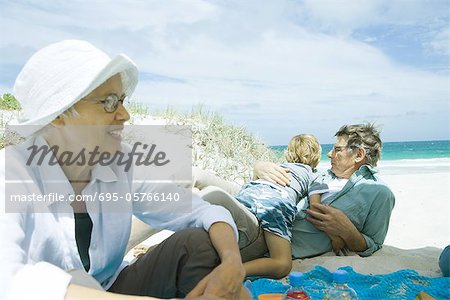 Family relaxing on beach