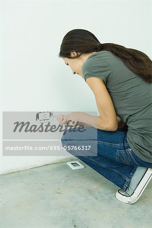 Woman replacing outlet cover