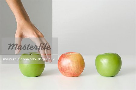 Woman's hand selecting apple