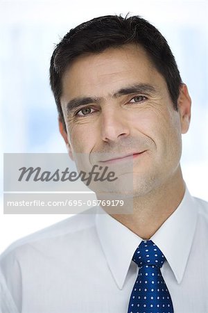 Businessman smiling at camera, portrait