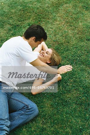 Couple lying together on ground, high angle view