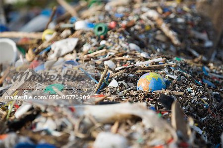 Globe in midst of landfill trash