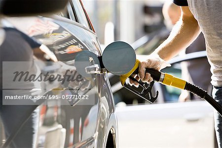 Refueling vehicle at gas station