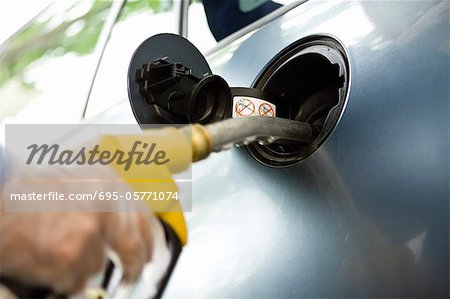 Refueling vehicle at gas station