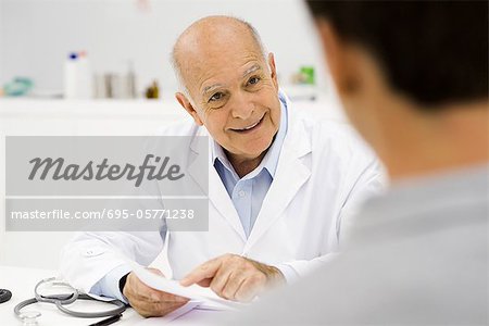 Doctor cheerfully explaining positive test results to patient