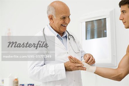 Doctor bandaging patient's wrist