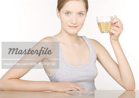 Woman holding up glass of juice