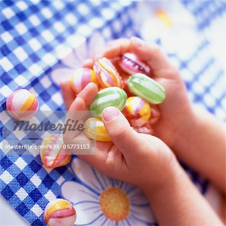 Child's hands holding candy, close-up