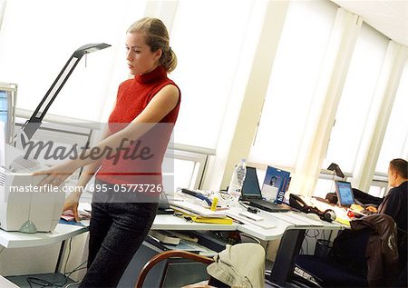 Woman using printer in office