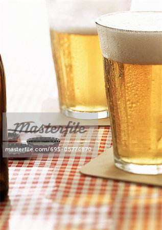 Two glasses of beer on cafe table, close-up