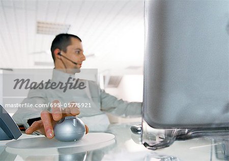 Man at desk using cordless mouse