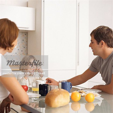 Mother and father with daughter at breakfast table