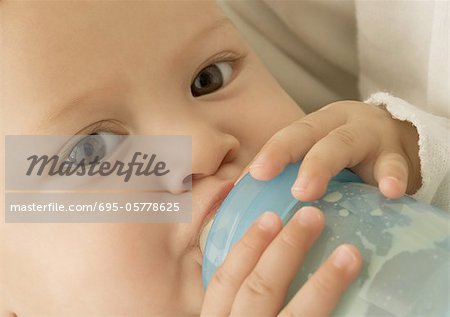 Baby drinking from bottle, close-up