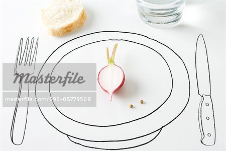 Half a radish and two peppercorns on plate, bread nearby
