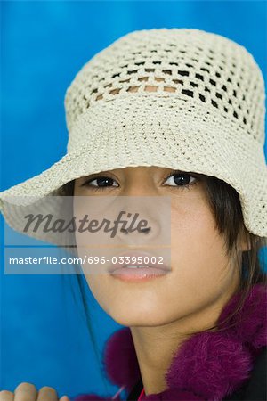 Teenage girl wearing hat, looking at camera, portrait